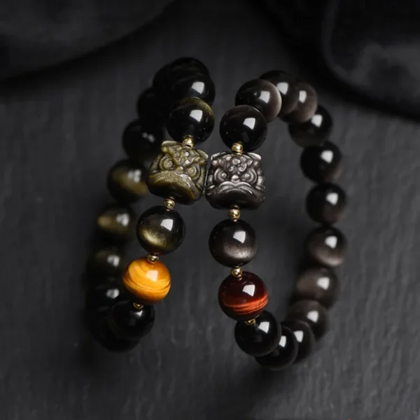Pair of obsidian lion head bracelets with gold and silver sheen variations