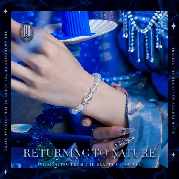 Model holding a handmade crystal healing bracelet in blue and white tones