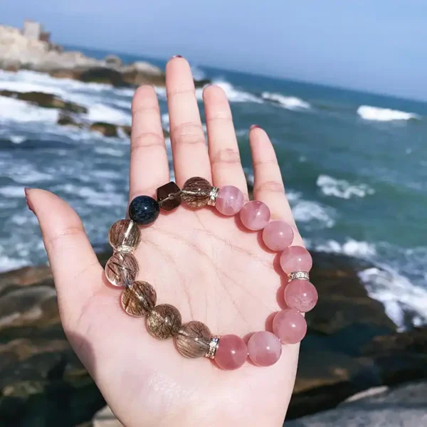 Bracelet resting in hand with natural rock background