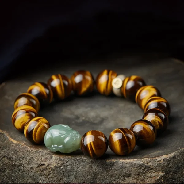 High-polish Yellow Tiger Eye beads arranged with a detailed green Hetian Jade Pixiu charm and a silver zodiac accent bead.