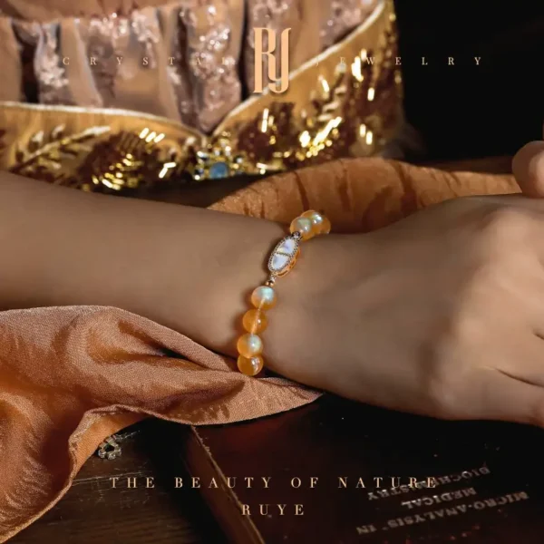 Close-up of women’s crystal and pearl bracelet – 925 silver gold-plated clasp