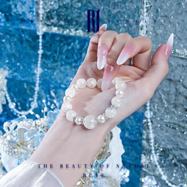 Snowflake crystal and pearl bracelet held in hand – handmade white crystal jewelry