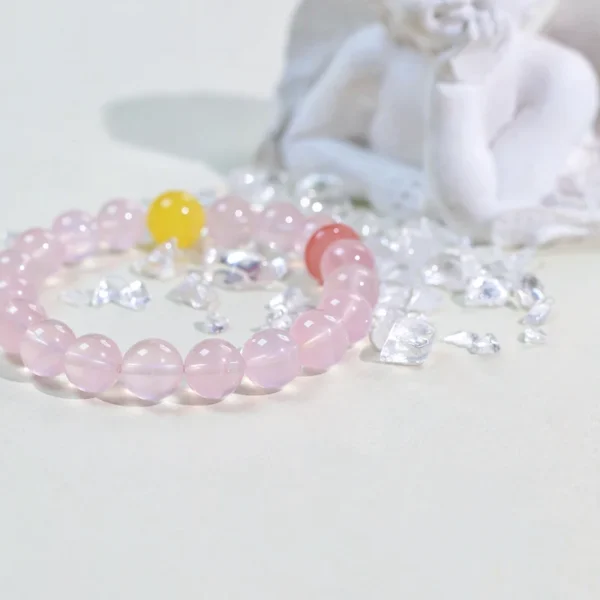 Woman wearing pink crystal bracelet with yellow and red beads