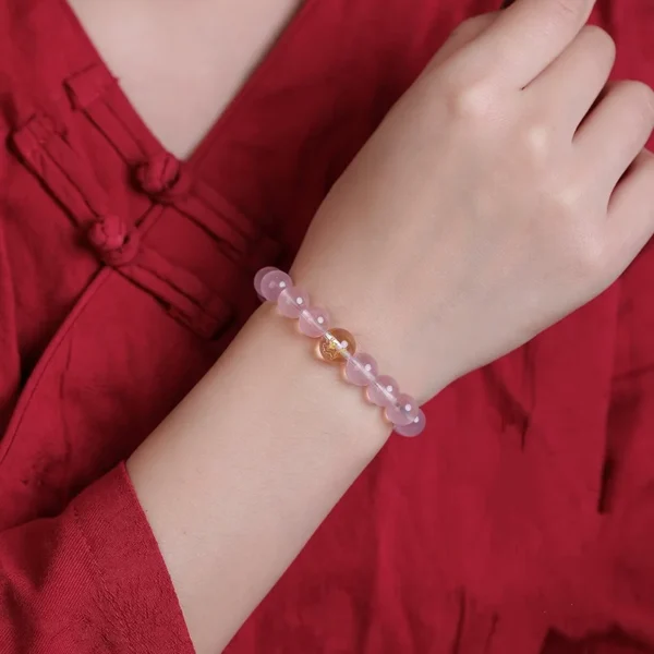Woman wearing rose quartz zodiac compatibility bracelet