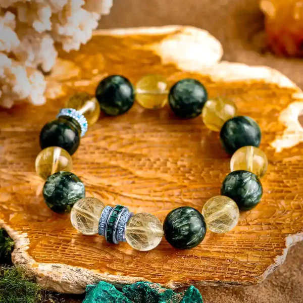RUYE bracelet with Seraphinite and golden quartz laid on wood texture