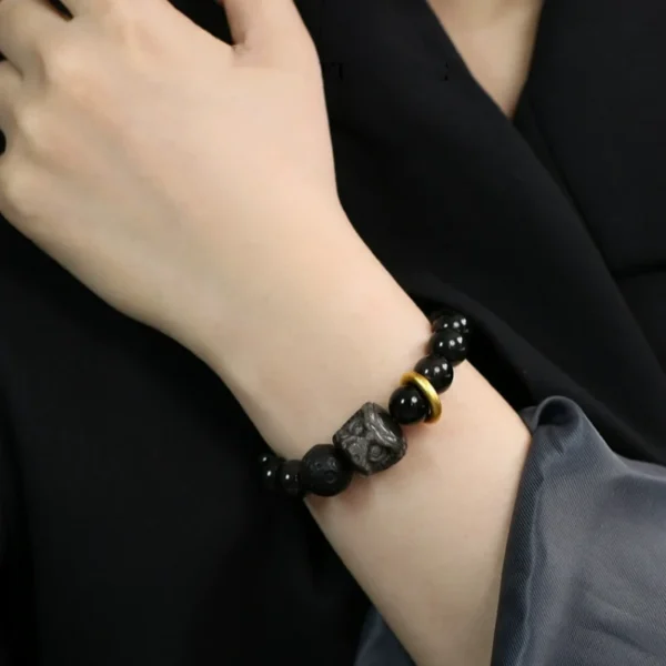 Model wearing black obsidian lion bracelet