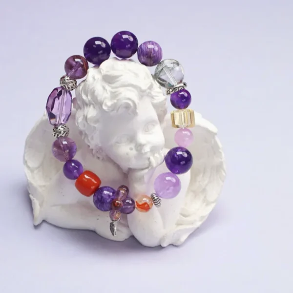Courage crystal bracelet displayed with angel statue