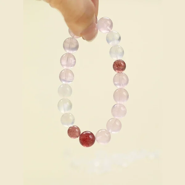 Hand holding Sweet Harmony love crystal bracelet