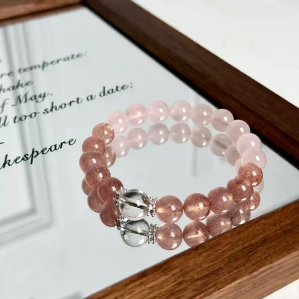 Elegant pink crystal bracelet arranged in a wooden mirror frame