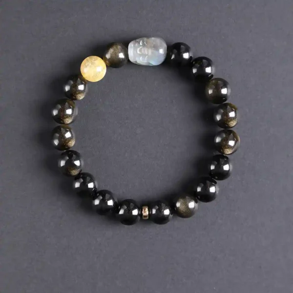 Top view of Moonlight Guardian bracelet with polished black and gold energy stones