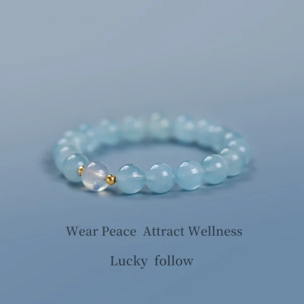Aquamarine and moonstone healing bracelet on soft blue background
