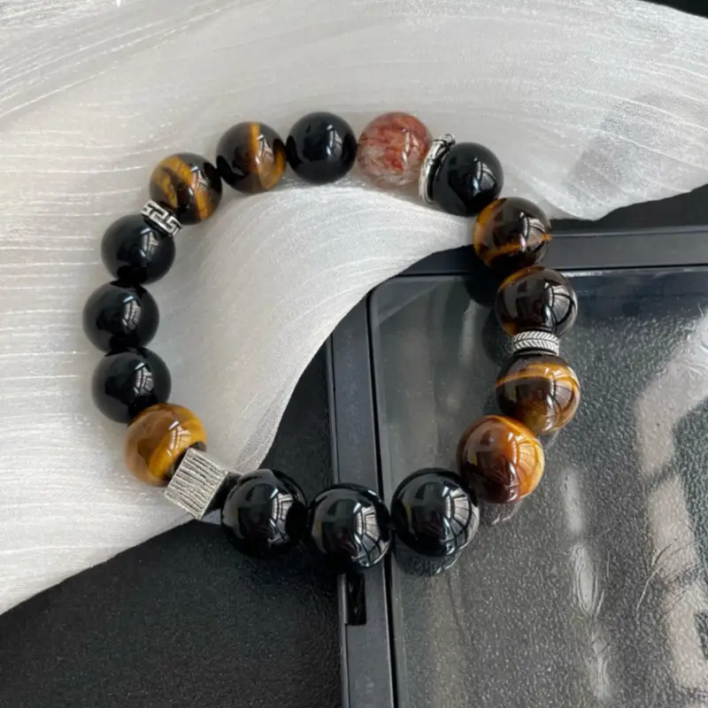 Obsidian and tiger eye crystal bracelet with silver spacers on white silk
