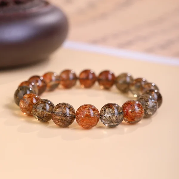Black Gold Super Seven energy bracelet displayed on a neutral background