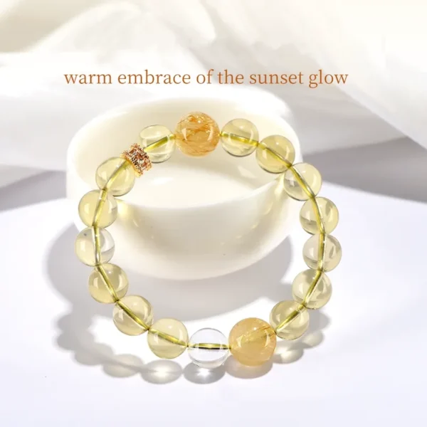 Yellow crystal bracelet in bowl with quote about wealth and sunlight