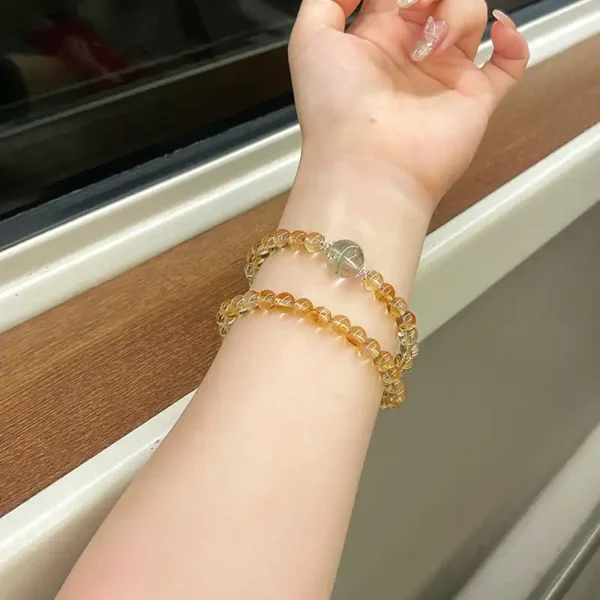 Yellow Topaz & Green Phantom bracelet worn on wrist, layered