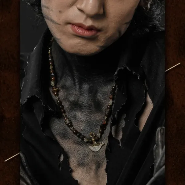 Male model wearing the Asura God necklace over black distressed shirt