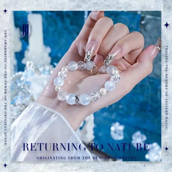 Close-up hand holding white moonstone and pearl bracelet from RUYE handmade crystal jewelry collection