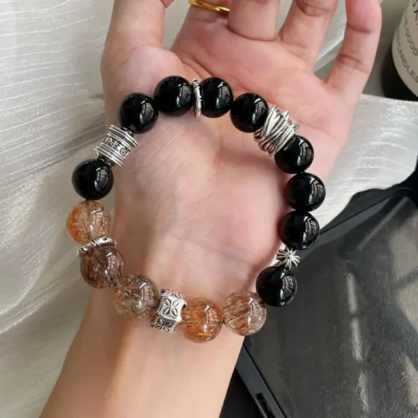 Obsidian and Super Seven crystal bracelet worn on hand