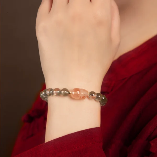 Woman wearing Red Hair Quartz Pixiu energy bracelet