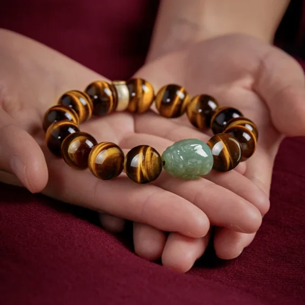 Elegant Yellow Tiger Eye bracelet featuring a green Hetian Jade Pixiu bead and 925 silver zodiac charm detail.