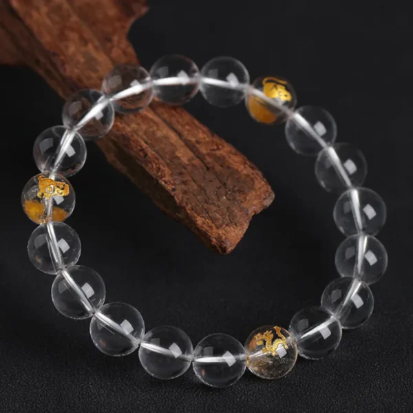 Chinese zodiac crystal bracelet showing Rat, Dragon, and Monkey symbols in gold
